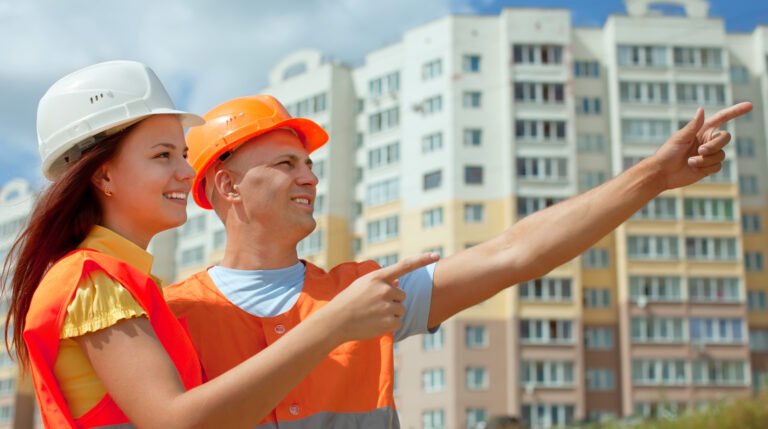Two architects in front of building site